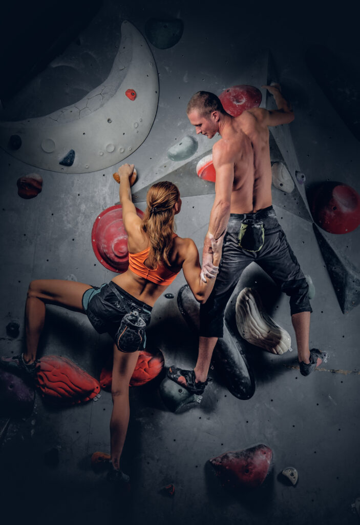 Male and female climbing on an indoor climbing wall. Image by fxquadro on Freepik